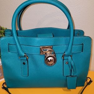 Gently used Michael kors Hamilton Teal Large leather with lock and key.